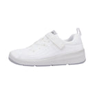 A white school shoe with Velcro straps and a flat sole.